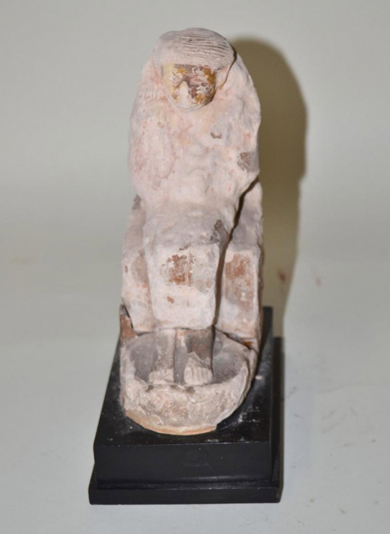 Seated Egyptian Deity: Carved plaster sculpture of a seated ancient Egyptian diety. Worn and cracked through bottom. Mounted on a stepped ebonized wood base. Overall: 4" W x 5.5" D x 8.75" H.