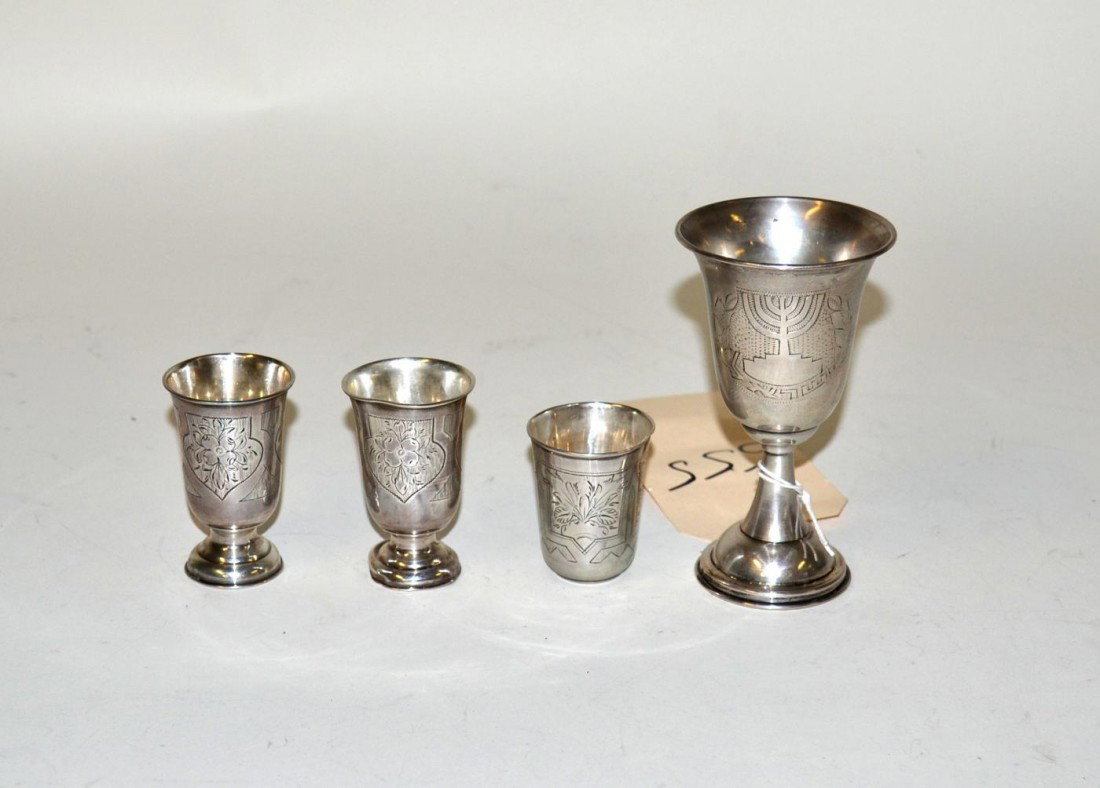 Four Silver Cups: One beaker, pair of etched cups, together with one larger cup. Bases dented.
