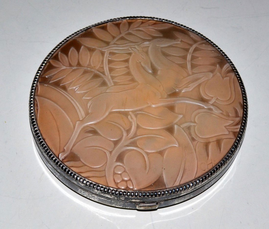 Art Deco Compact: An oversized Art Deco sterling silver compact having a moulded celluloid lid depicting two running deer. Initialed CH on moulded lid. 6" in dia.