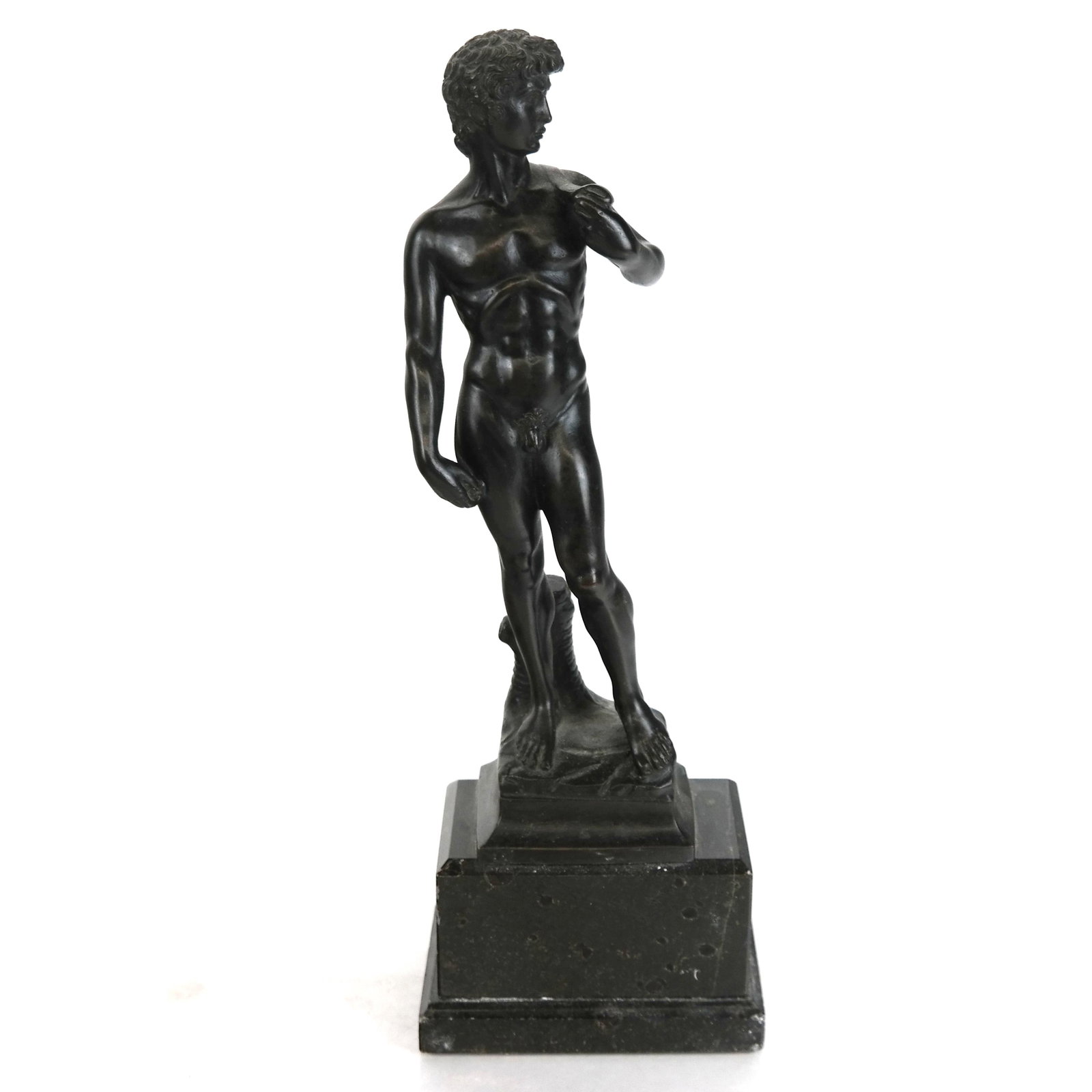 Grand Tour-Style Bronze Sculpture of David: Grand tour-style bronze sculpture of David, modeled nude and standing contraposto holding his slingshot, after the original by Michelangelo (Italian, 1475-1564), on marble plinth base. [Overall: 13" H