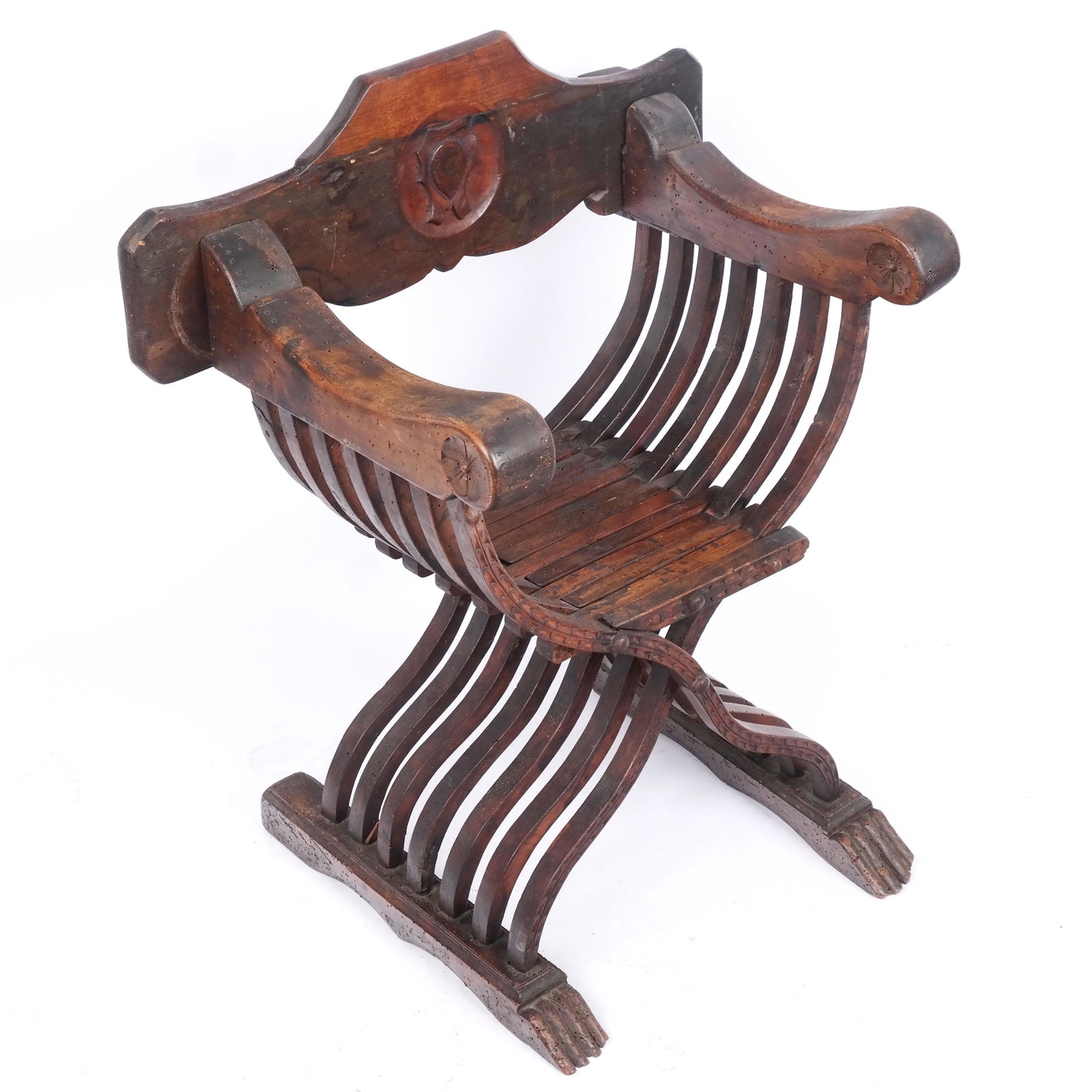 Renaissance-Style Walnut Savonarola Armchair: 19th century and later Italian Renaissance-style walnut Savonarola armchair, the articulating back splat with carved shield cartouche above the arms, with repeating floral details over folding seat an