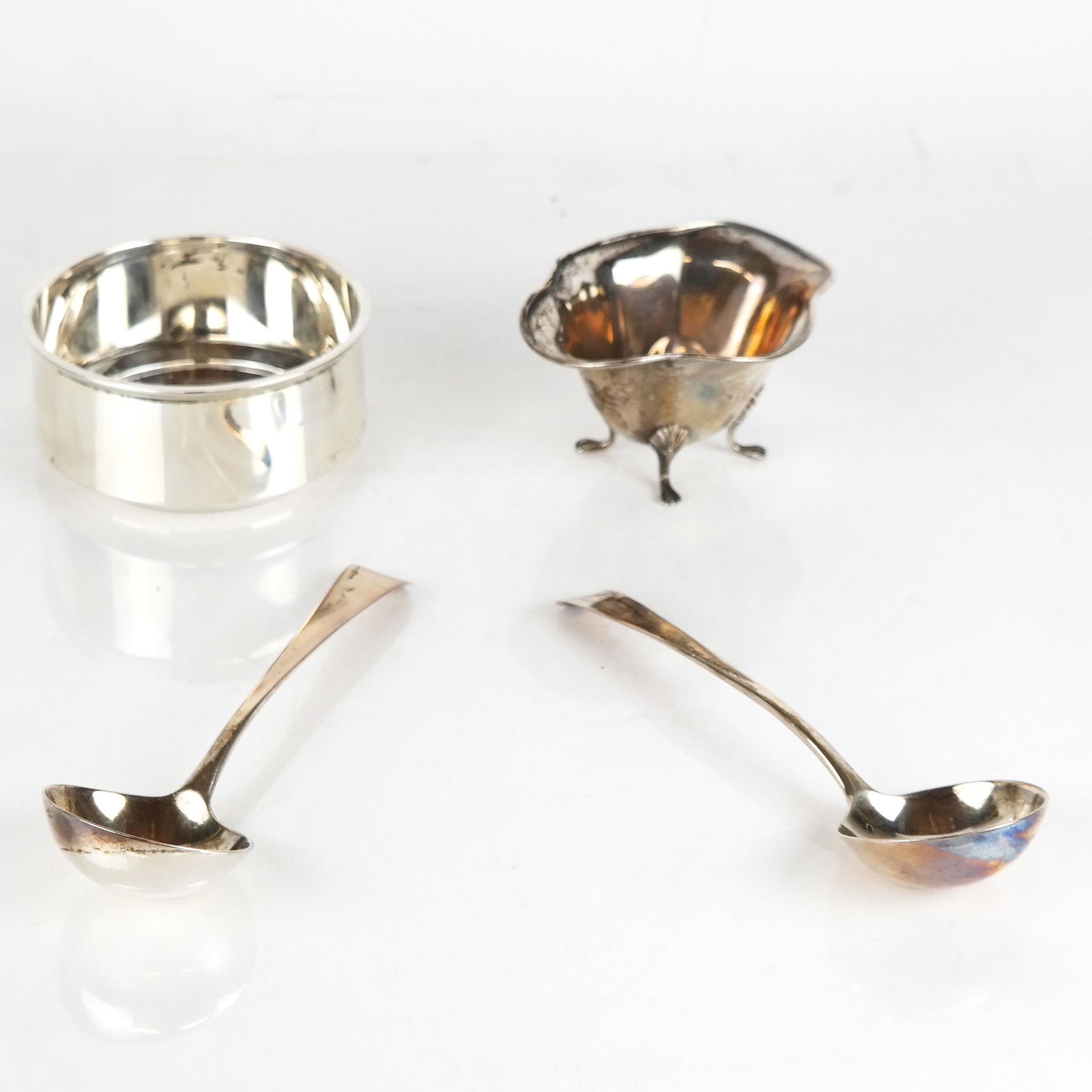 Four Sterling Silver Articles: Four sterling silver articles, including a pair of 20th century London English silver small ladles [7" L], a Bailey, Banks & Biddle footed bowl [2 1/2" H x 4 1/2" W], and a Gorham wine coaster [2" H x