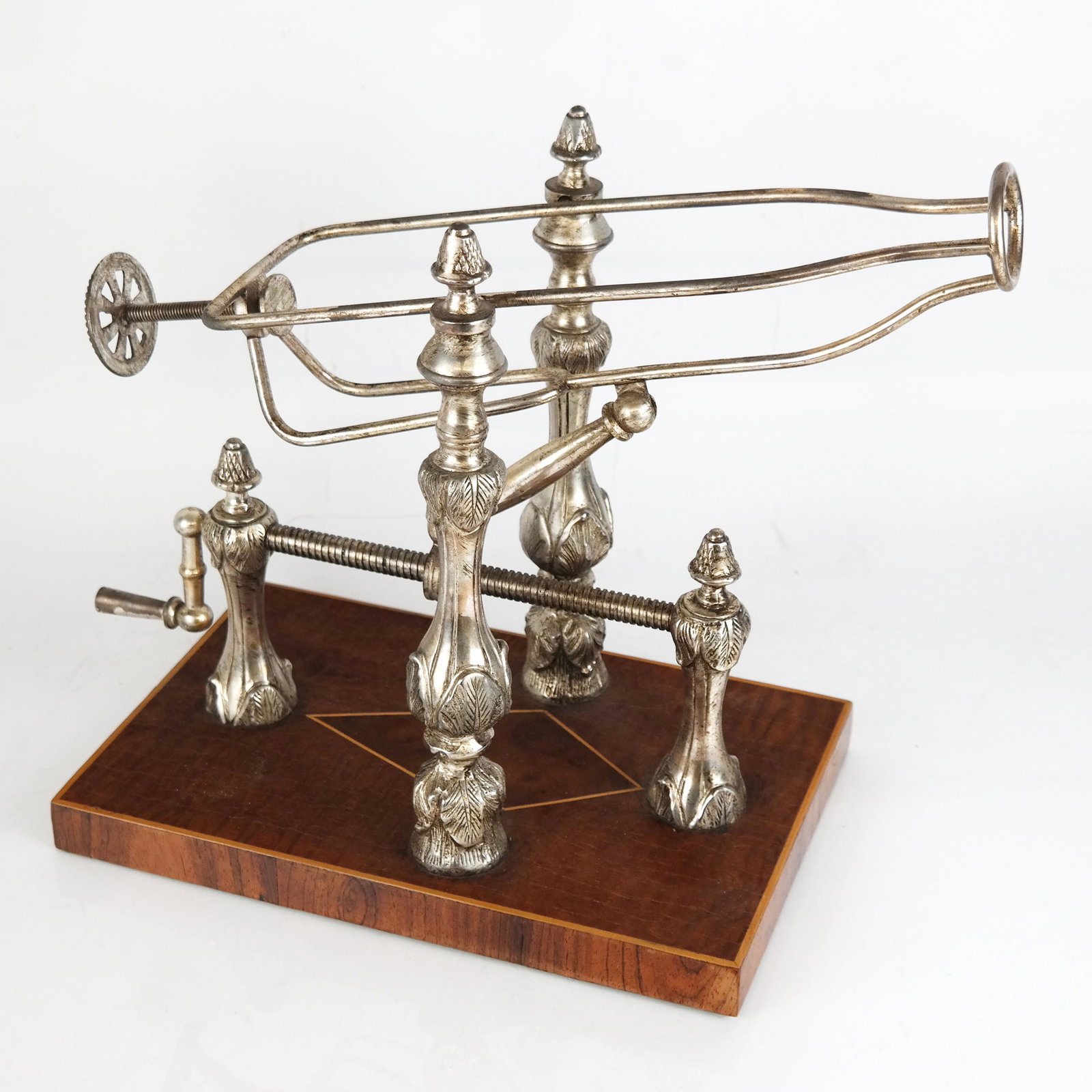 Vintage Mechanical Silver Plate Wine Cradle/Pourer: Vintage mechanical silver plate wine cradle/pourer on inlaid wooden base; no marks. [12" H x 16" W x 7 3/4" W]. In good condition with minor wear to plate and oxidation.