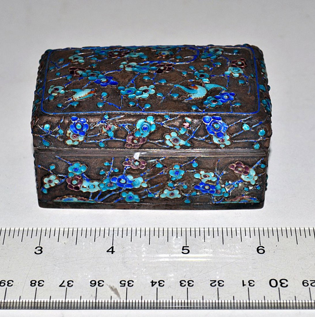 Chinese Enameled Silver Box: Hinged rectangular silver box with hummingbird and floral decor. 3.25" x 1.75" x 1.5". Some chips, overall in good condition.