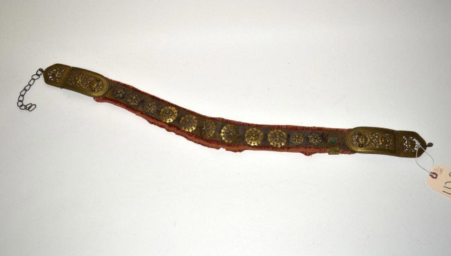 Antique Oriental Belt with Rosette Appliques: Antique belt with Oriental bronze openwork buckles, faux emerald accents, and eleven rosette appliques. 37.75" L x 2.5" W. Embroidered velvet band is worn, otherwise the belt is complete and in good c