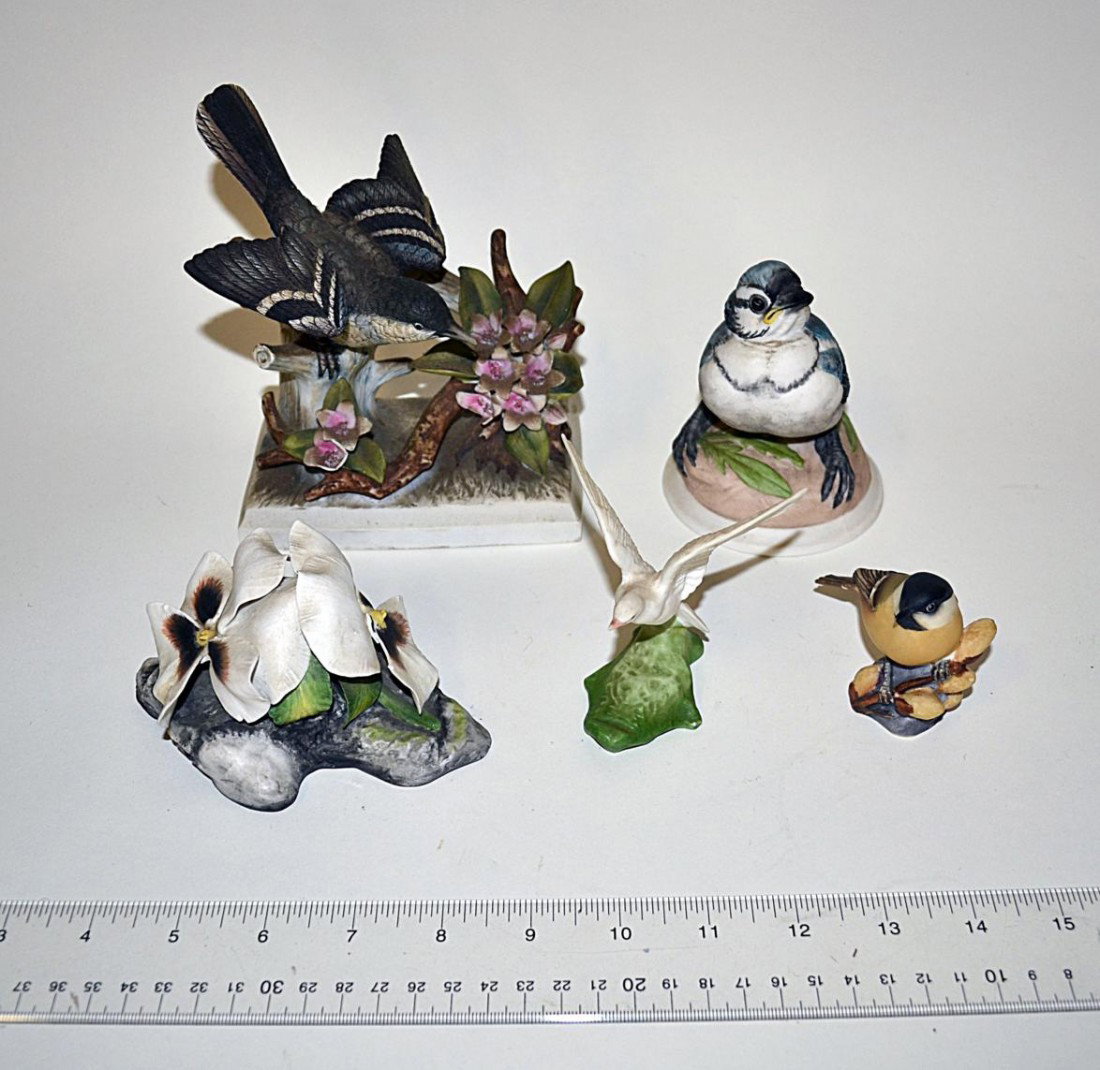Four Bisque Bird Sculptures & Other: Comprises a blue bird, blue jay, robin, and dove. Accompanied by a Boehm double pansy. Manufacturers include Royal Worcester & Boehm.