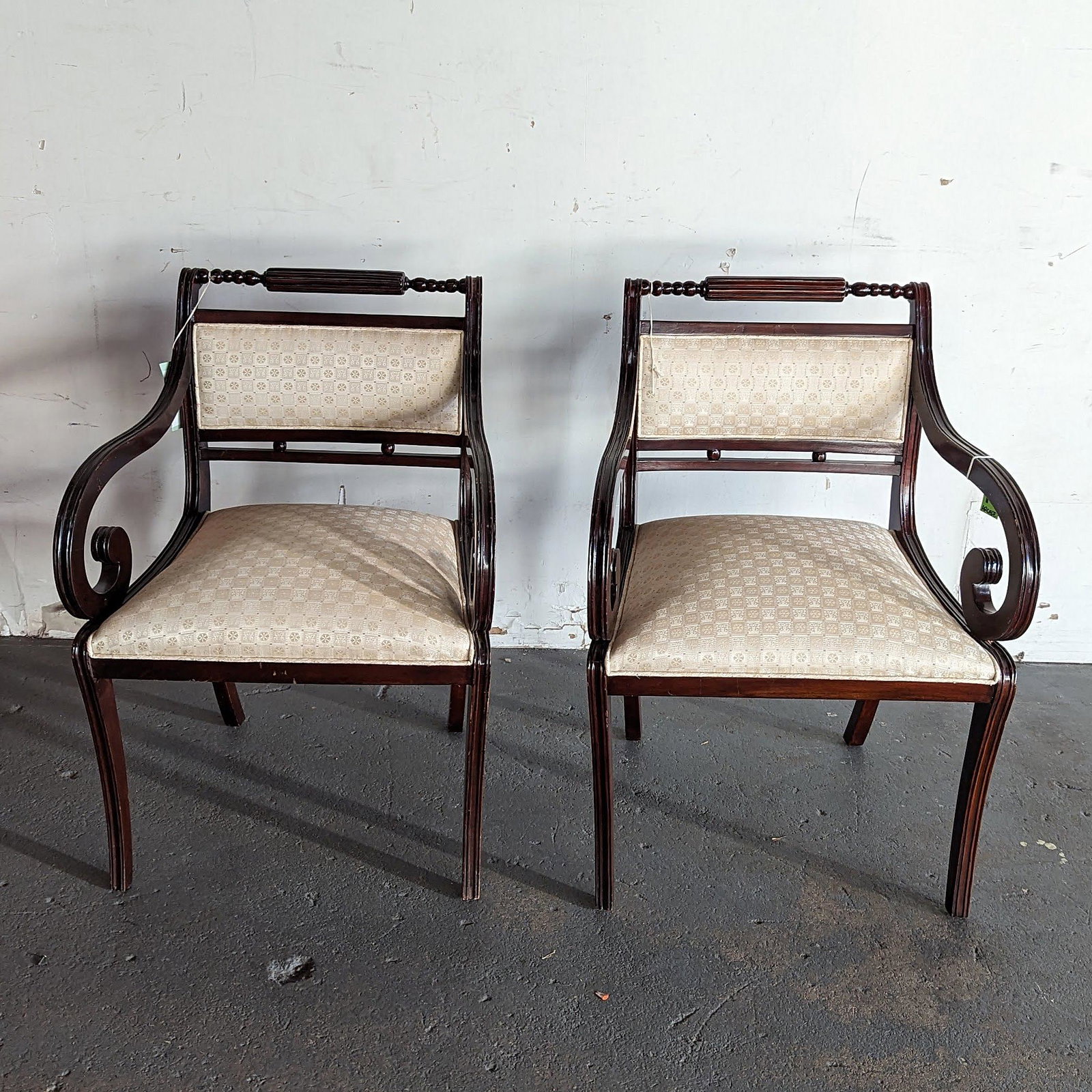 Custom Regency-Style Armchairs: Custom-made Regency-style armchairs, Italian made, each having scrolling arms, on saber legs, with upholstered backs and seats. In good condition.