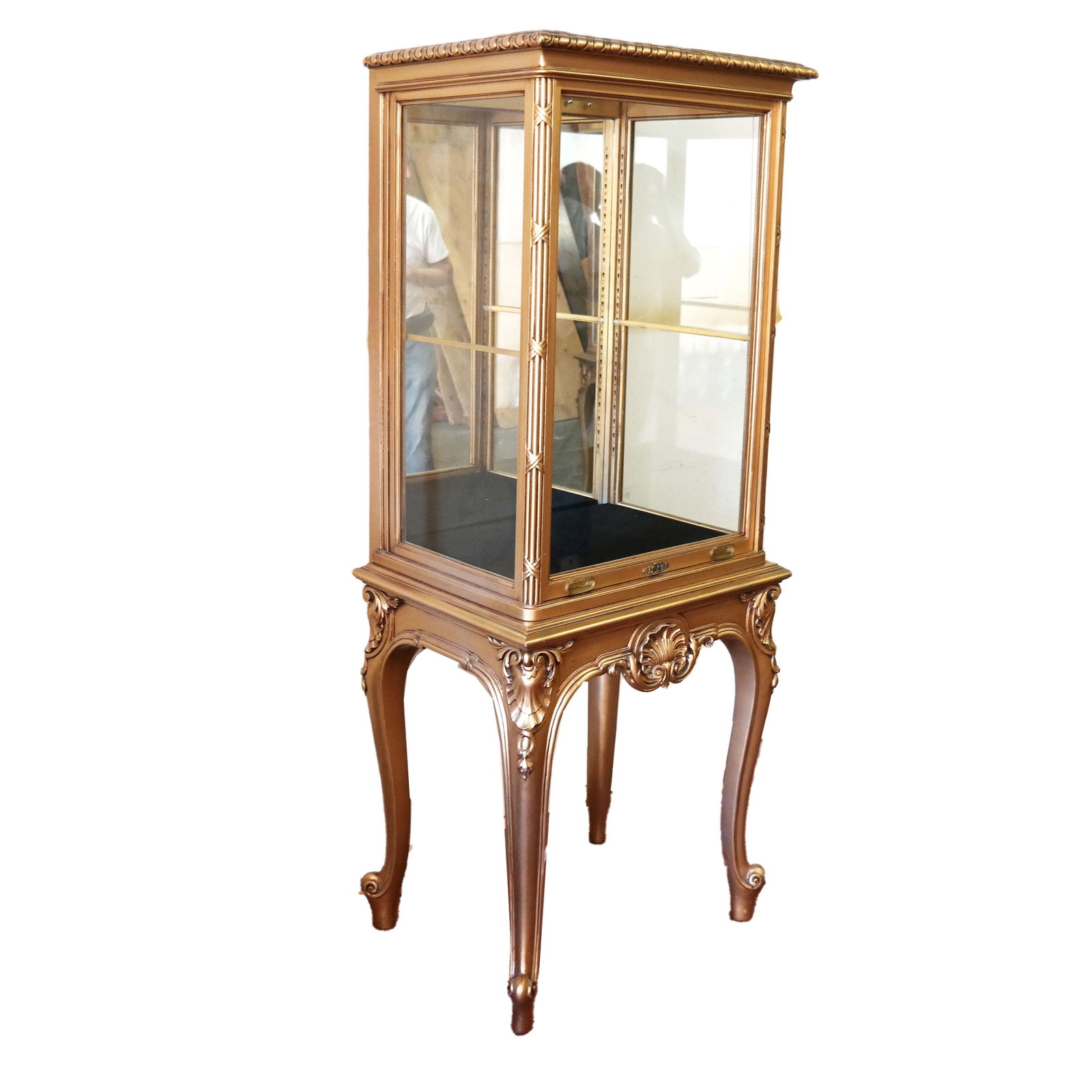 Louis XVI-Style Gilt Carved Vitrine: Louis XVI-style mirror back glass case with lift front door, on gilt carved stand with shell front skirt and knees. Door on weighted pulley system. Purchased from J.E. Caldwell Gallery, Philadelphia, 