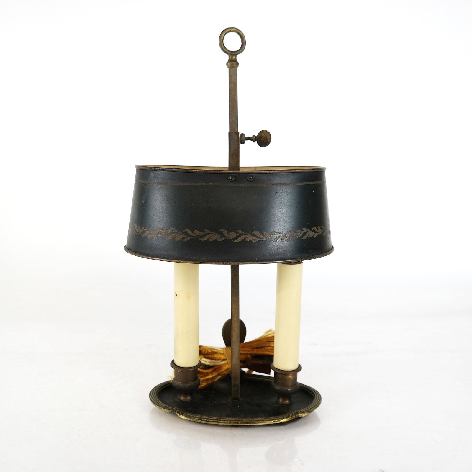 French Bronze and Tole Bouillotte Lamp: French bronze and tole oval form bouillotte lamp. [13 1/2" H; 3" H x 6" W x 4" D (shade)]. Worn.