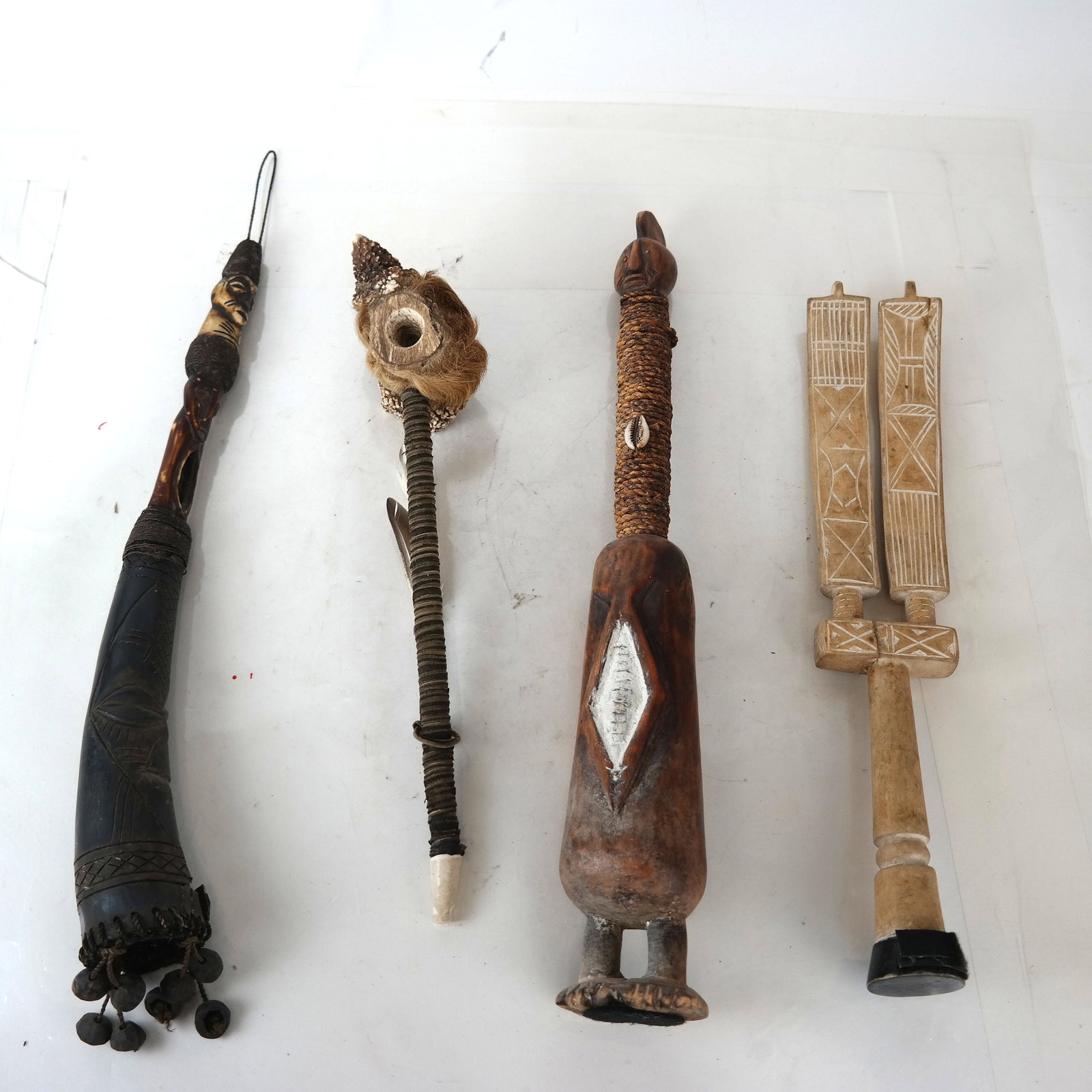 Four African naturalistic Arts: Four items, including a pipe, figures, and others. [Longest: 18" L]. In good condition.