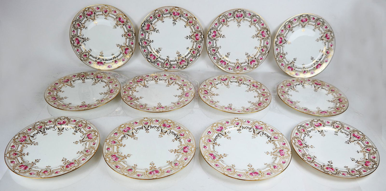 Twelve Wedgwood 10" Dinner Plates: Twelve Wedgwood 10" dinner plates, with unusual gilt foot rim, numbered X4673, hand-decorated with fine gilding, bearing Portland vase mark and design number. In good condition.
