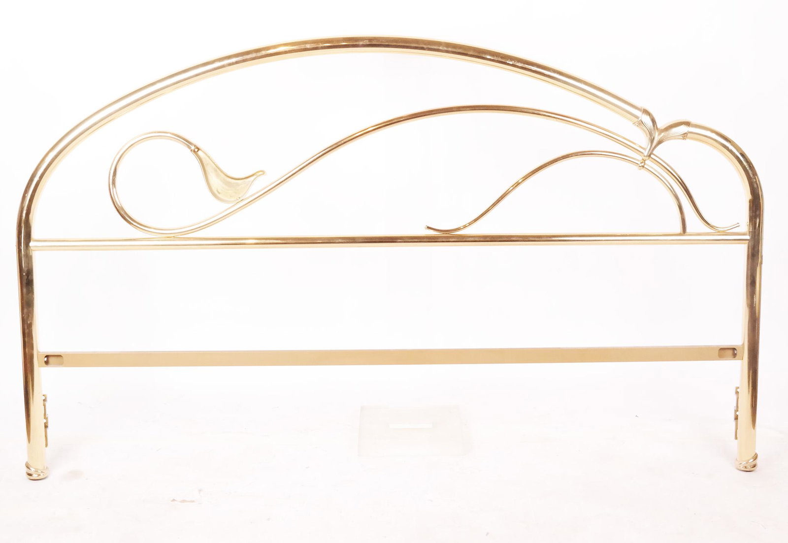 Modern Brass Headboard: Modern brass headboard, of tubular design with scrolling lily motif. [47" H x 79 1/2" W]. Typical scuffs and wear.