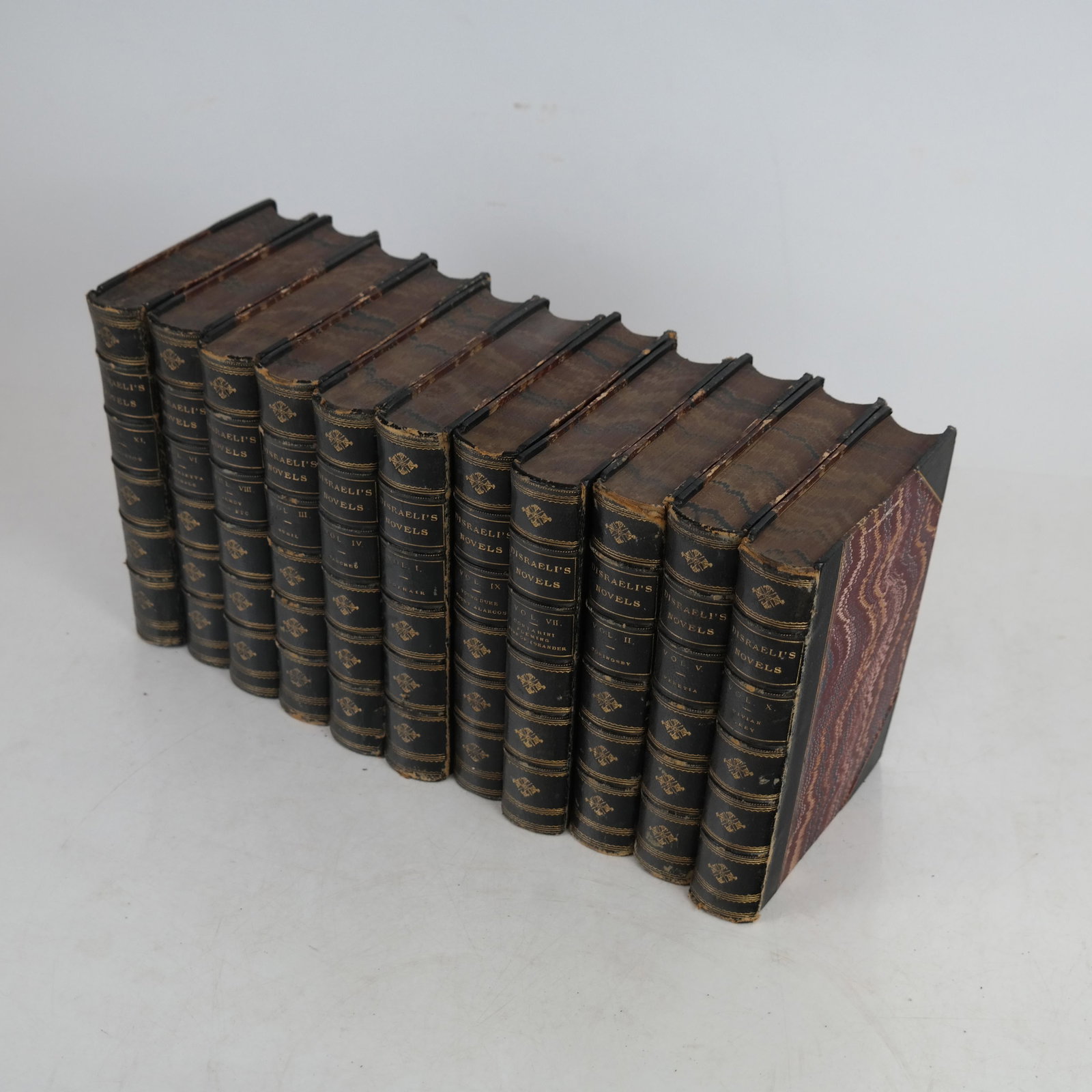 Disraeli's Novels - 11 Volumes, Circa 1875: 11 volumes (possibly incomplete), circa 1875, comprising the novels of Benjamin Disraeli, Earl of Beaconsfield and Prime Minister of the United Kingdom during the reign of Queen Victoria in three-quar