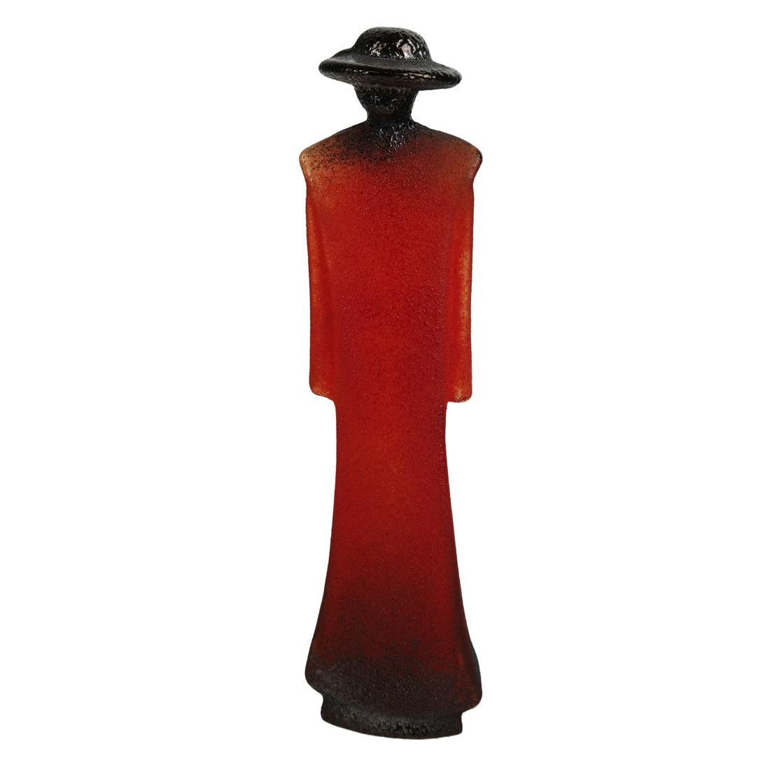 Kjell ENGMAN: Art Glass Standing Figure: Kjell Engman (Swedish, b. 1945) art glass standing figure with red and black hot powder over clear glass form; signed "Kosta Boda" and "K. Engman" no. 90556. [7 1/2" H x 2" W x 2" D]. In good conditio