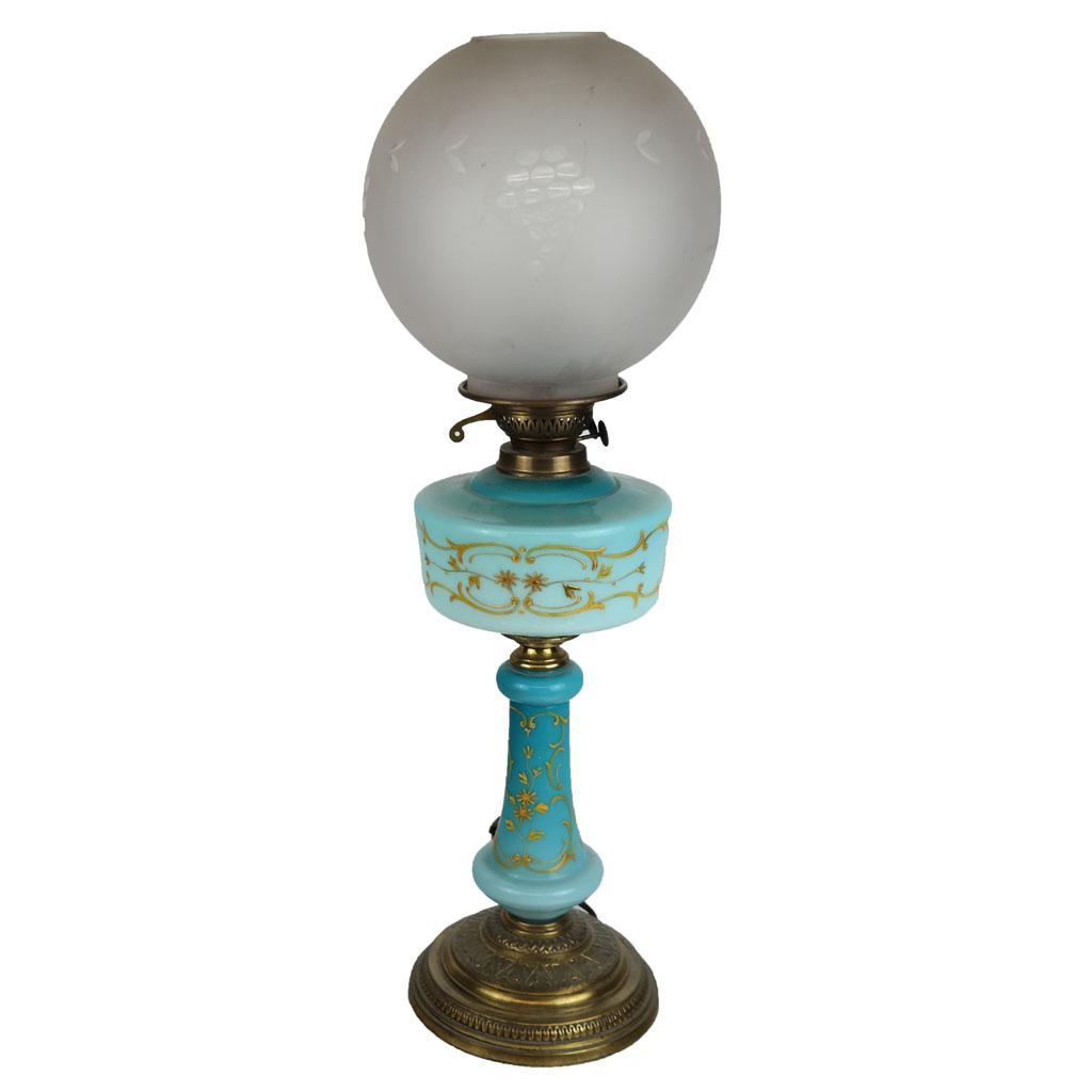 Art Nouveau Bronze and Glass Table Lamp: Lamp with milk glass hurricane globe shade and gilt embossed glass body. [27 1/2" H; Shade: 8" Diam.].