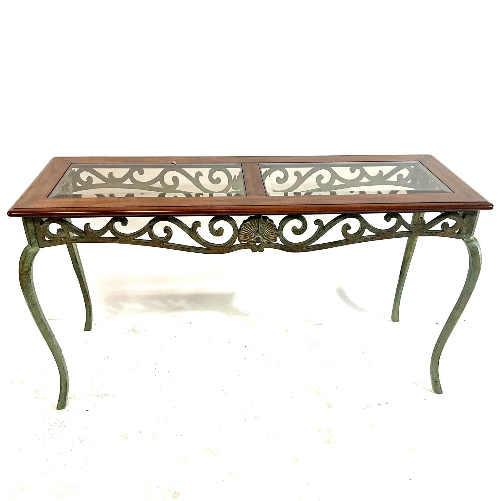 Iron and Mahogany Parsons Table: Parsons table with fancy shell motif apron and two glass inserts. [28" H x 51" W]. In good condition.