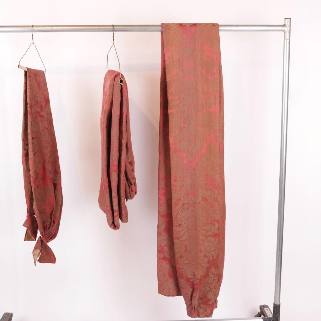 Red/Rose and Brown Floral Set of Curtains (3): Two curtains and one swag in a red/rose and brown floral design. [Curtain: 66" W; Swag: 112" x 64"]. Fading to leading edge.