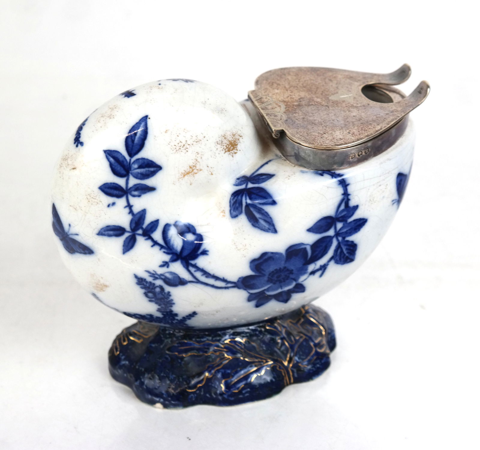 English Porcelain & Silver Plate Condiment Cup: Condiment cup with gilt trim on blue and white porcelain cornucopia-shaped cup with hallmarked silver plate cover. No spoon. [6" H x 4" W x 7" D].