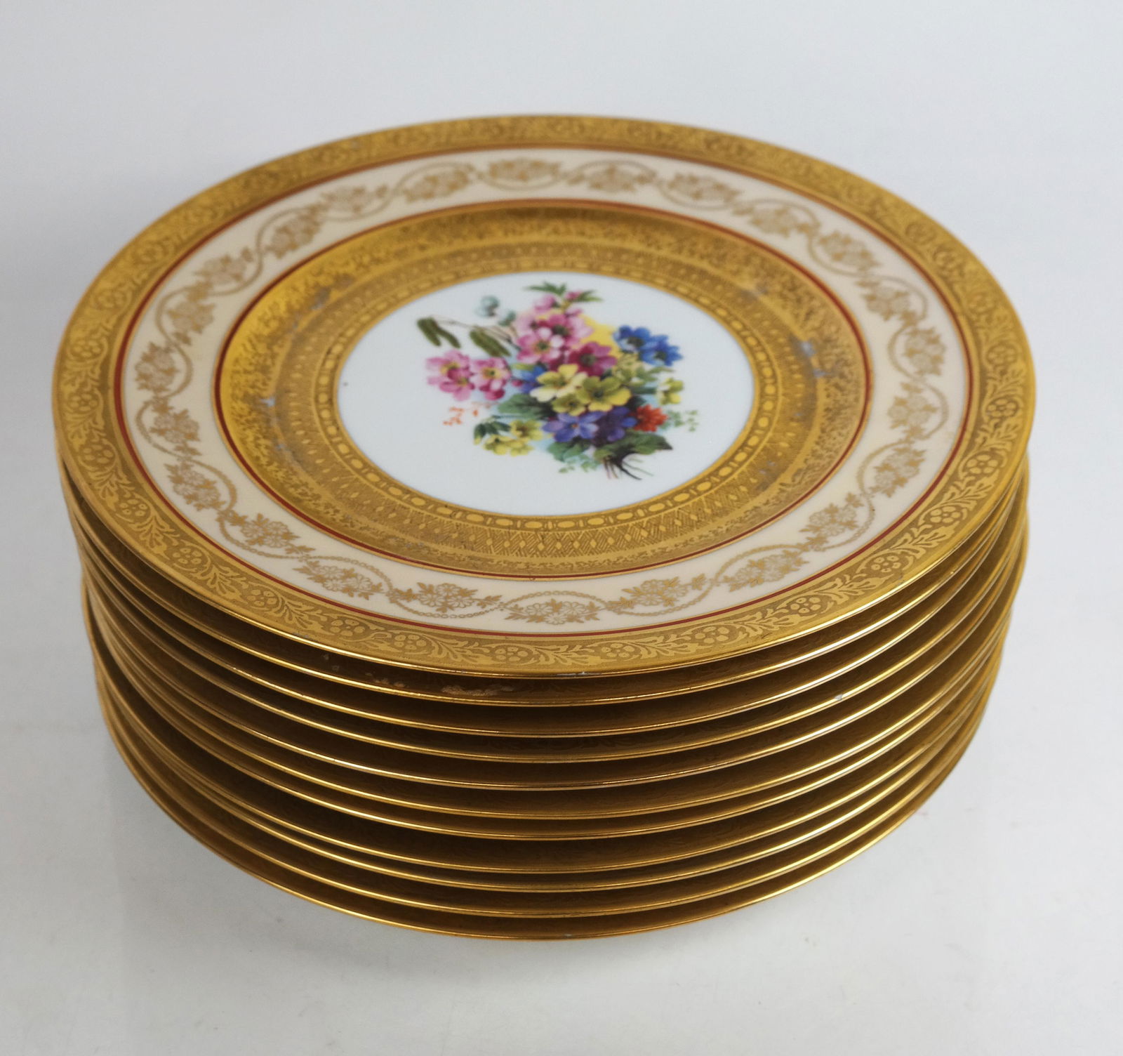 Royal Bavarian Hutschenreuther Dinner Plates: Royal Bavarian Hutschenreuther painted porcelain dinner plates, circa 1900, with gilt accented cream and red borders around central floral sprays, marked to bases, retailed by Macy's, New York. [10 3/