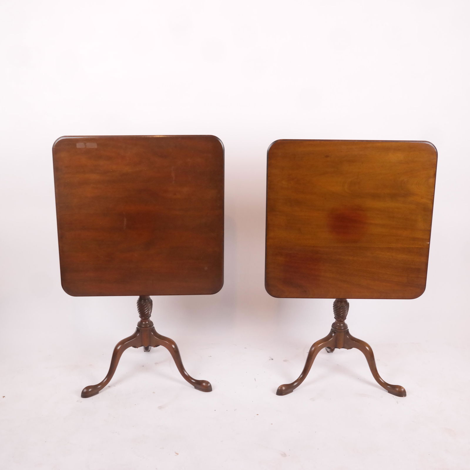 Pair of Kittinger, NY Tilt Top Table: Pair of 20th century Kittinger, NY tilt top tables, branded "CW - Williamsburg Restoration Collection". [42" H x 26" W x 21" D (tilted); 27" H x 26" W x 26" D (down)].