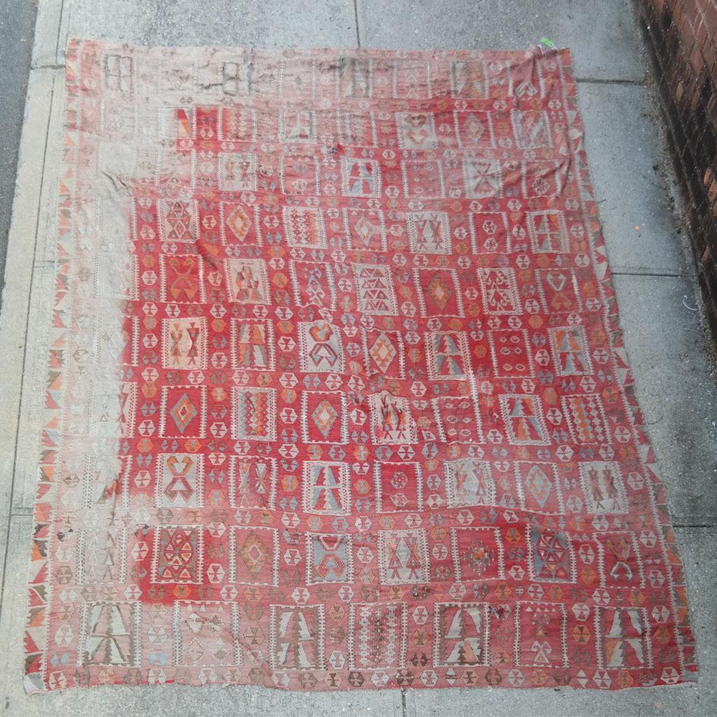 Vintage Turkish Kilim: Vintage Turkish kilim. [161 x 110 inches]. Heavy wear, faded, and damages.