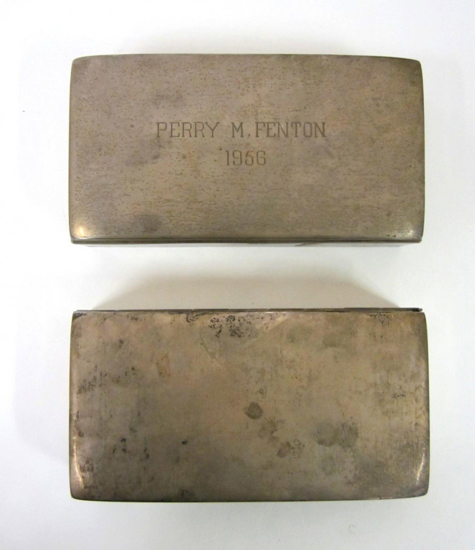 Two Sterling Silver Cigarette Boxes: Two nearly identical boxes, one engraved "Perry M. Fenton / 1956". Both 6 1/4" W x 3 1/4" D x 1 1/2" H.