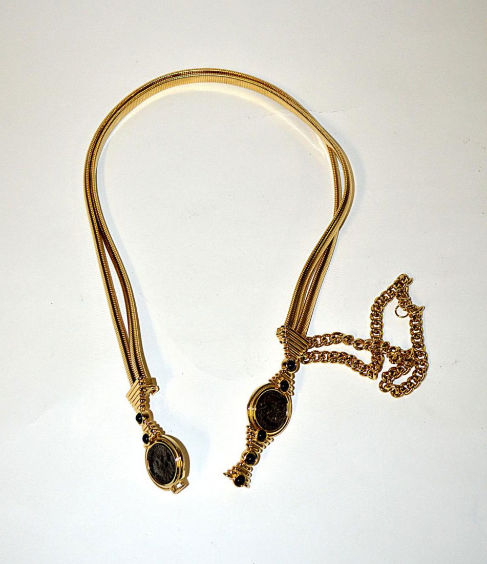 Judith Leiber Gold-Tone Belt: Composed of two gold strands, black cabochon accents, and ancient coin motif. 30 1/4" L. In excellent condition.