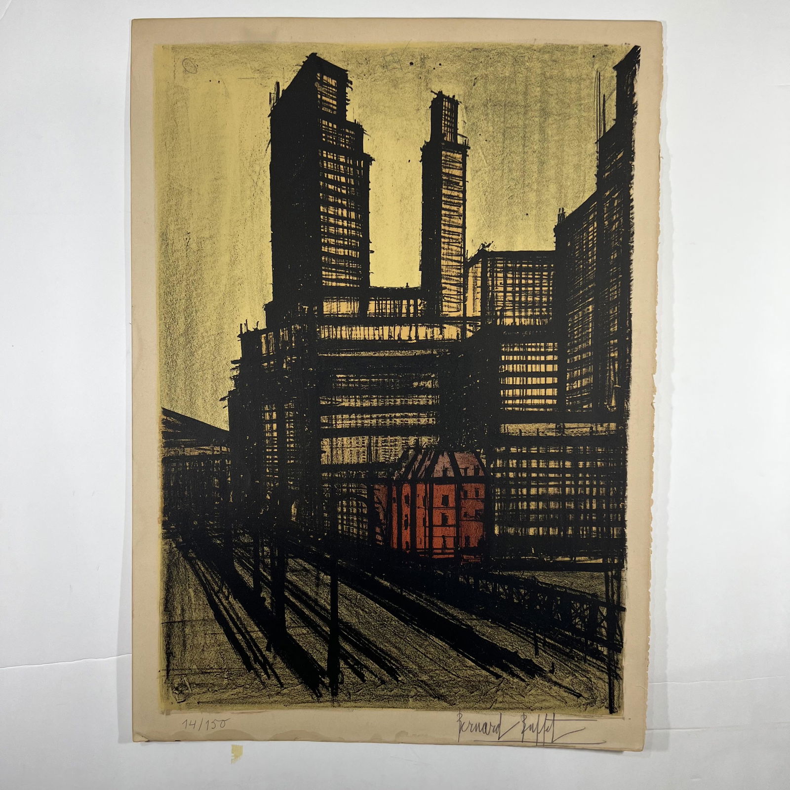 Bernard BUFFET: Cityscape - Lithograph: Bernard Buffet (French, 1928-1999) lithograph of a cityscape, signed in pencil and numbered "14/150". Provenance: Phyllis Lucas Gallery, NYC. [29" H x 21"]. Toning, slight tears to corners.