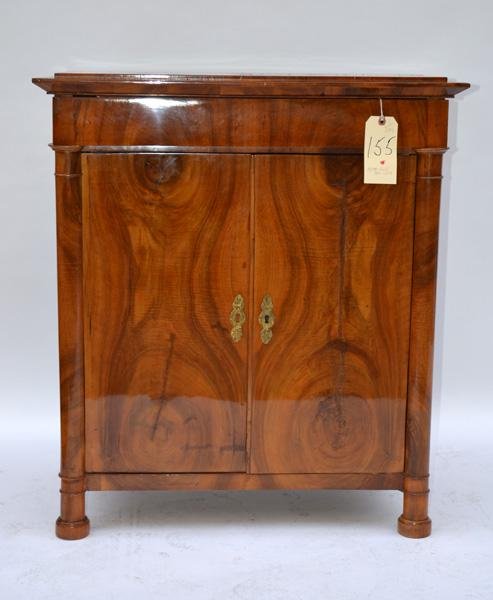 Biedermeier Cabinet: Oyster shell Biedermeier cabinet having one drawer above two doors with column supports. 30.5" L x 17.75" D x 34.75" H.