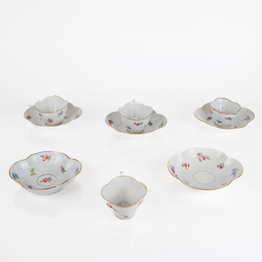 Meissen German Porcelain Cups & Saucers: Eight Meissen German porcelain coffee/tea cups and saucers, 19th century, each with hand-painted floral decoration and gilt borders, the bases with blue underglazed crossed sword marks. Some with crac