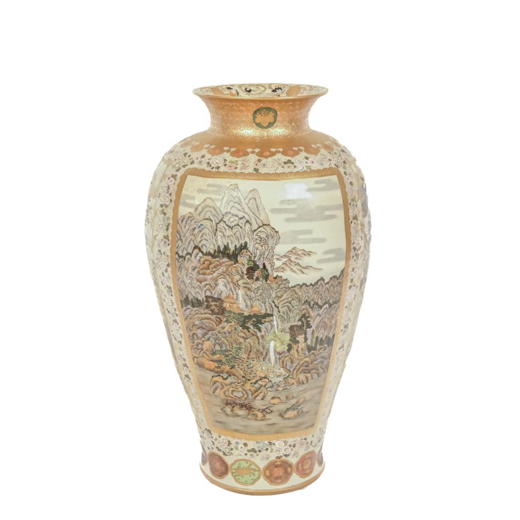 Large Japanese Meiji Period Vase: Large and fine Japanese porcelain vase, depicting birds in trees panels and a mountainous landscape, gilt bordered. [Vase: 33" H x 18" Diam.; Overall: 41 1/2" H]. In good condition.