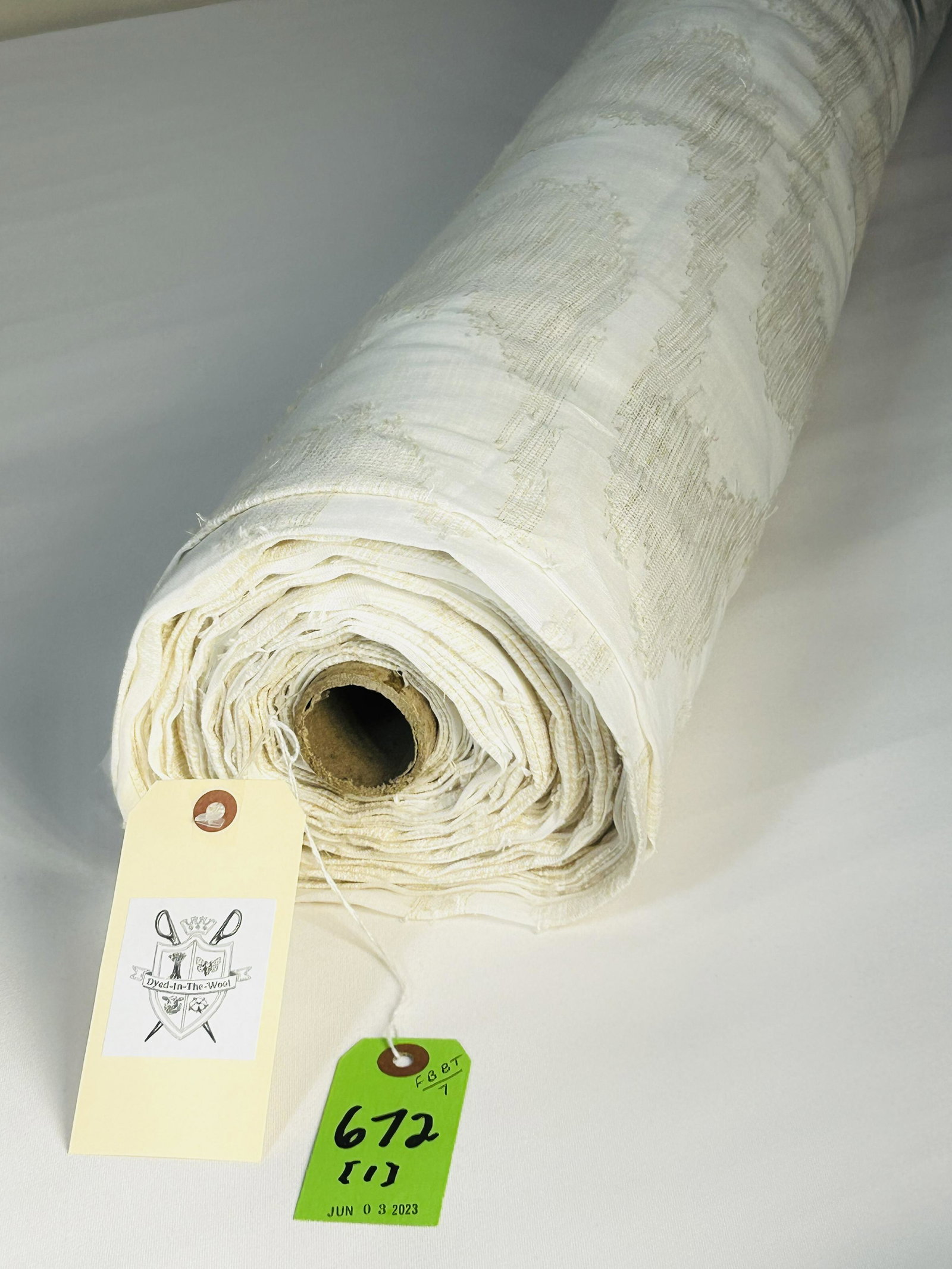 Colefax & Fowler's 118"-Wide Sheer Fabric: 25 1/2 yards of Colefax & Fowler's "Marina" fil coupe wide width polyester sheer, #11116-01, colorway "Ecru", 118" wide. The Ikat-style motifs have a mix of golden sand and off-white on a solid ecru g