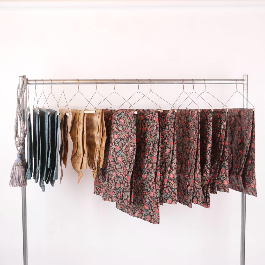 Group of Small Curtains & Accessories: Seven unlined curtains in William Morris-style fabric [Each: 44" H x 36" W] with a three-part valance in cream and gold embroidery and two blue ties, together with four blue curtains, ties and valance