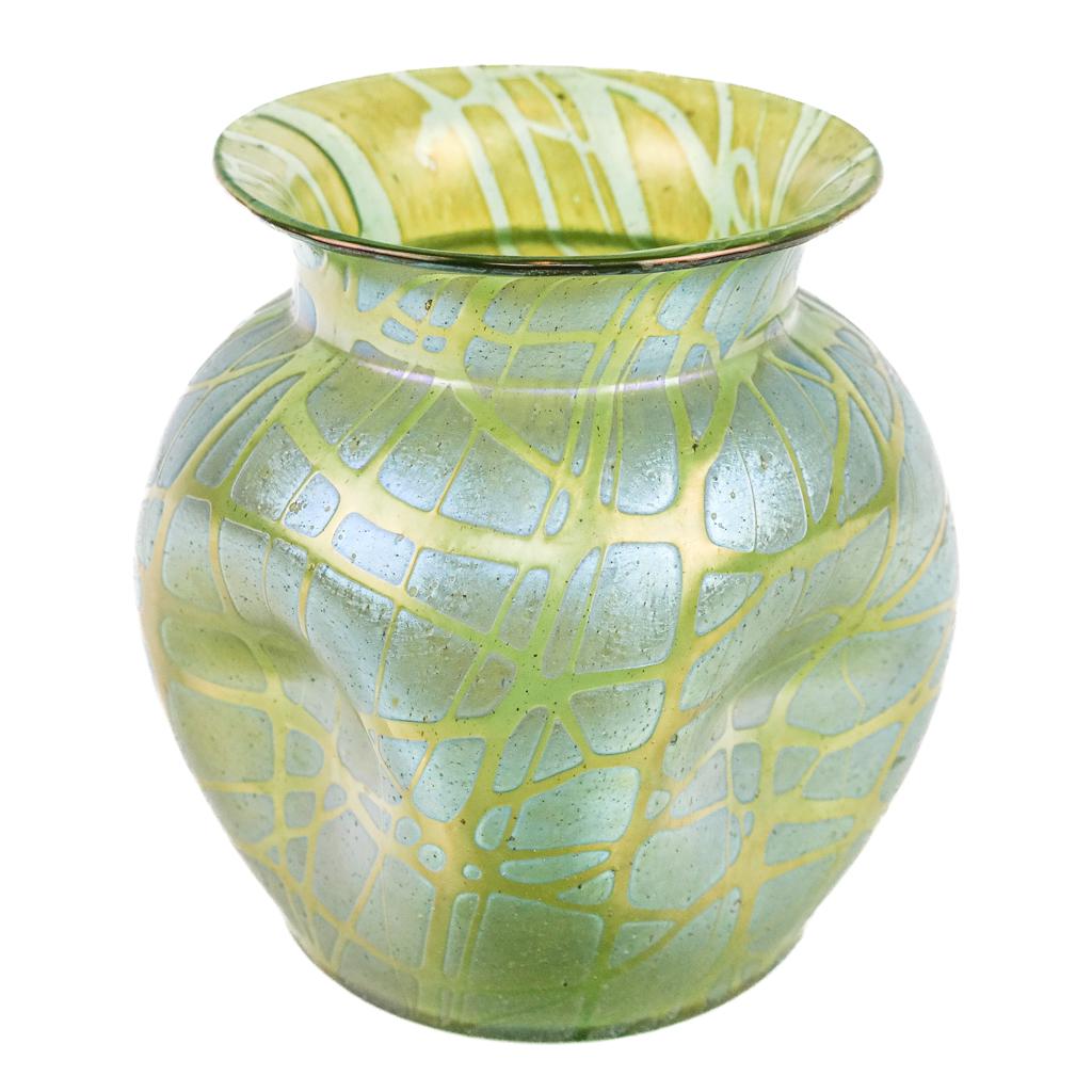 Iridescent Glass Vase: Iridescent Art Nouveau glass vase with trailing decoration, having a pinched globular body of blue/green hue, in the style of Loetz, with polished pontil. ]6" H x 6" Diam.]. In good condition.