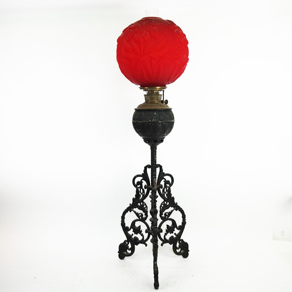Renaissance Revival Cast Iron Lamp: Renaissance Revival cast iron lamp for oil or kerosene, on a tripod base. [32" H x 14" Diam.]. Oxidation, losses and wear.