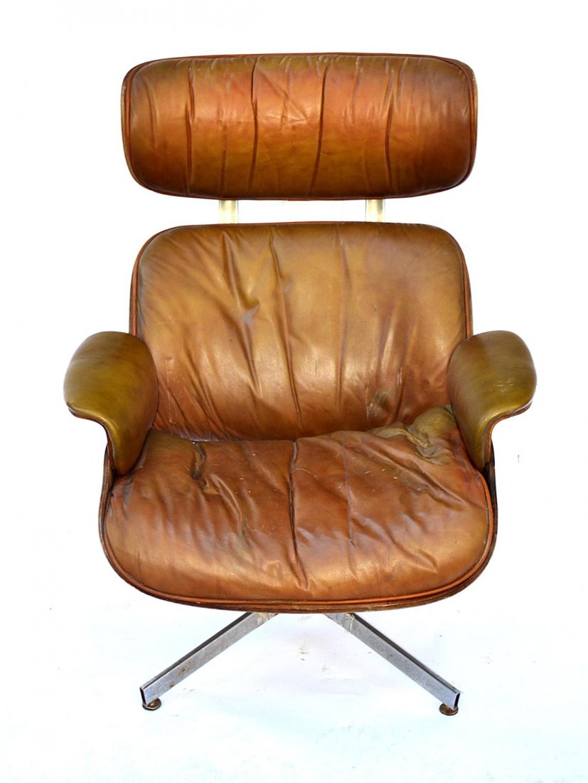 Vintage Eames Lounge Chair: Brown leather chair with hardware stamped "Frank Doerner." Chrome base needs restoration, wood finish bears wear consistent with age and use, otherwise complete. 32" x 30" D x 39 1/2". 15 3/4" to seat