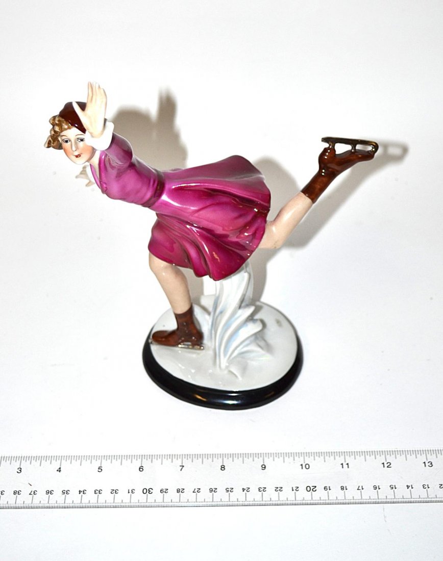 German Art Deco Skater - Fasold & Stauch: Female skater in purple dress, circa 1925. Bears the green Fasold & Stauch of Bock-Wallendorf initials. One small repair on backside heel of raised skate, otherwise in good condtion.