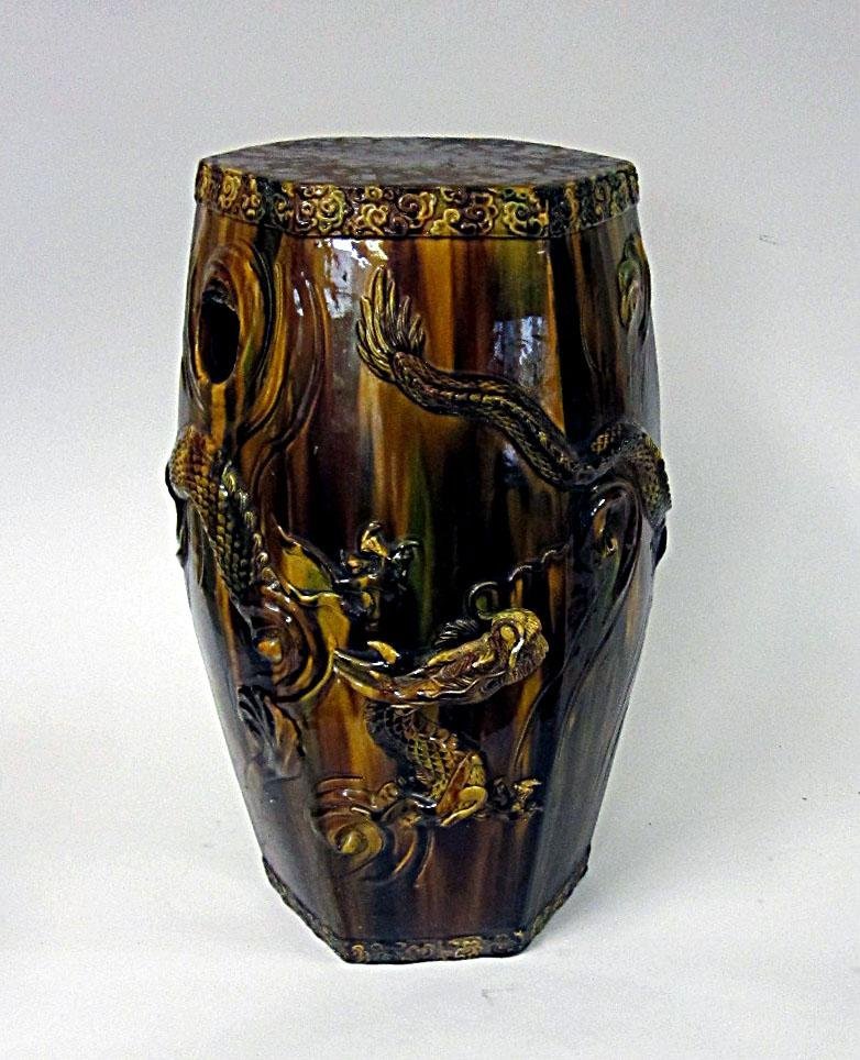 Glazed Pottery Umbrella Stand: Having a dragon relief, glazed earth tones with two handles. One handle as is.