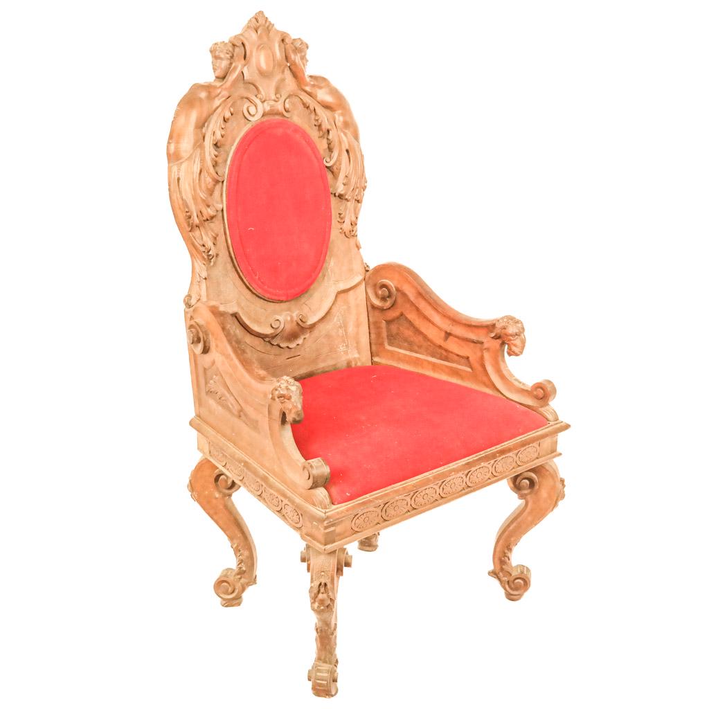 Italian Renaissance-Style Ornate Walnut Armchair: Renaissance-style walnut armchair having a female nude crest and ram arms, with red upholstered back and seat. Late 19th century. Loose frame.