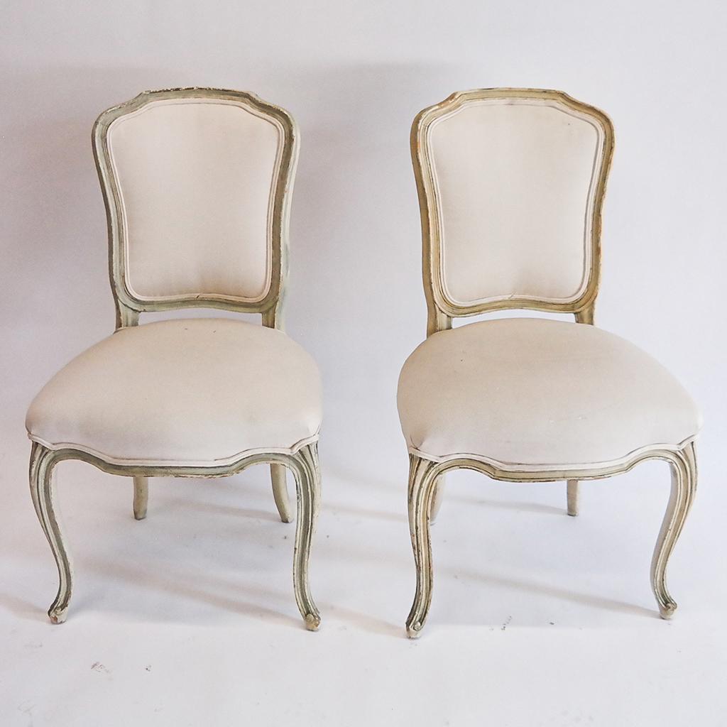 Pair of French Provincial-Style Side Chairs: Pair of French Provincial-style side chairs with paint decoration and carved frames. [36 1/2" H x 21" W x 20 1/2" D]. Wear to decoration and frames.