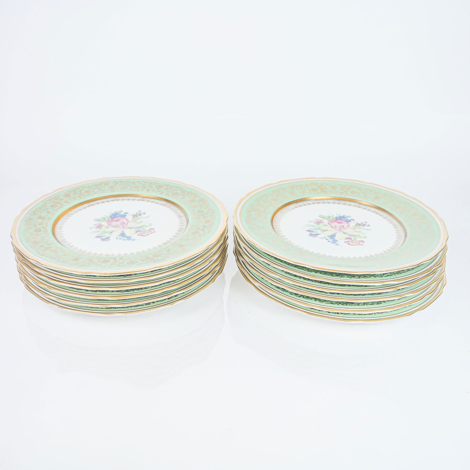 Set of 12 French Porcelain "Botanical" Plates: Numbered set of twelve French "Botanical" dinner plates, having a gold border and banding, with orchid centered bouquet design. [11" Diam.]. In good condition; no chips or cracks.