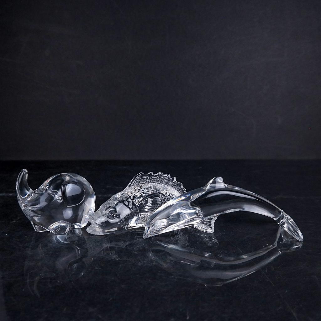 Three Baccarat Animals, Stamped and Signed: Comprising a stylized dolphin and elephant, and a realistic finned fish example. [Largest: 2 1/2 x 5 1/2 x 3 inches]. In good condition.
