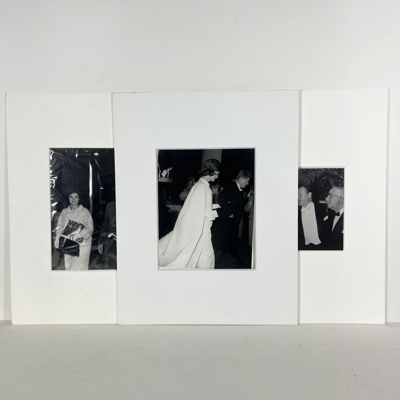 Three B&W Photos of Jacqueline & John F. Kennedy: Three black and white press photographs of Jacqueline and John F. Kennedy at various events, one with label to verso "President and Mrs. JFK walk to plane here today for a flight to Palm Beach..., 196