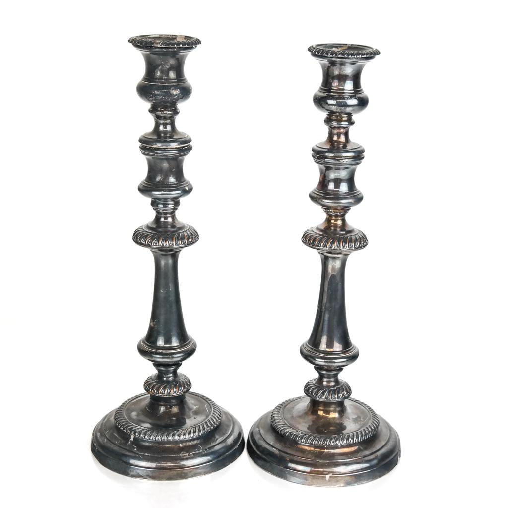 Pair of Silver Plate Candlesticks: With gadroon trimmed elements. No hallmarks. [13 HG x 5 diam inches].