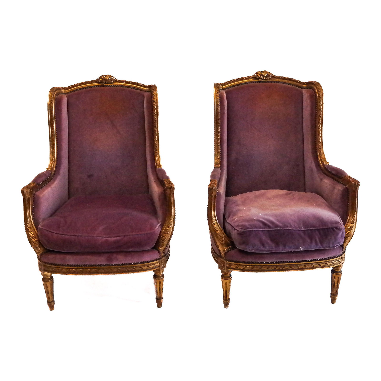 Pair of Louis XVI-Style Giltwood Bergeres: Pair of Louis XVI-style giltwood bergeres, the armchairs with velvet upholstery and carved frames. [43" H x 29" W x 27" D]. Losses to carving and finish; marks, stains and wear to fabric.