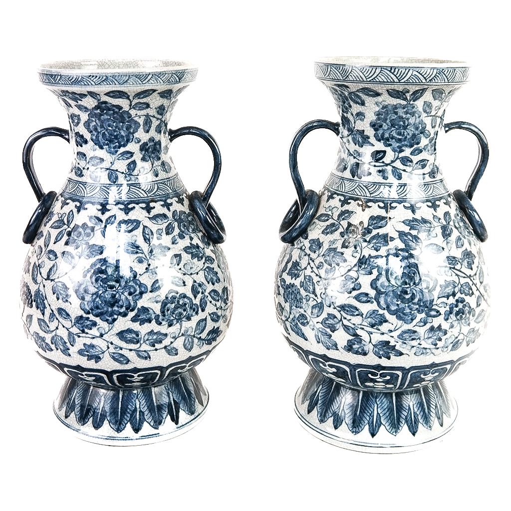 Chinese Pair of Blue & White Vases: Pair of 20th century Chinese blue and white crackle glaze vases with floral and foliate designs, unmarked. [13 1/2" H x 8 3/4" Diam.]. Minor marks and wear; residue.