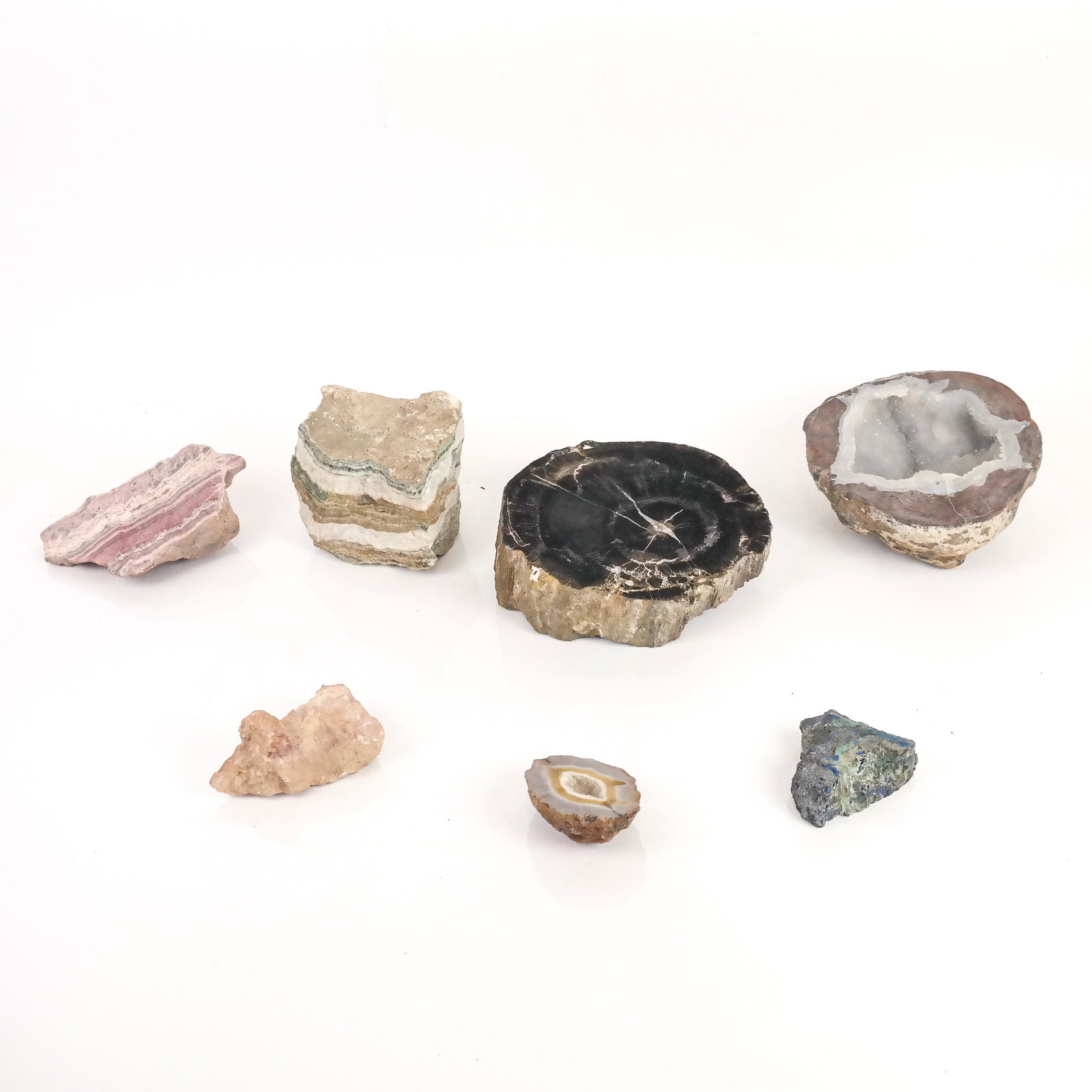 Group of 7 Stones and Rocks: Group of seven rough and polished stones and rock. [Largest: 3" H x 6 1/4" Diam.].