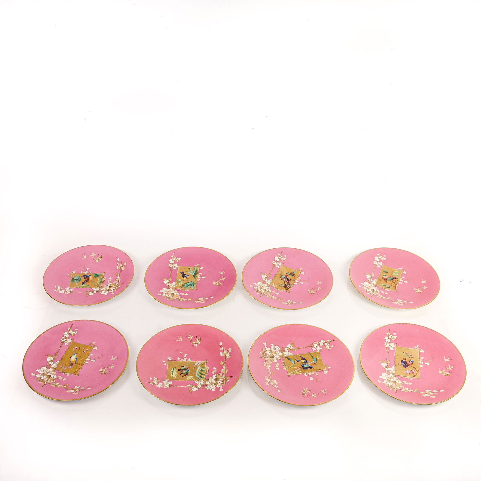 Brownfield's for Tiffany & Co. Porcelain Plates (8: Eight Brownfield's for Tiffany & CO. porcelain plates with gilt-accented bird and Japanese bamboo motifs on a pink ground, some marked to bases. [9 1/4" Diam.]. Scratches, marks and wear to decoration