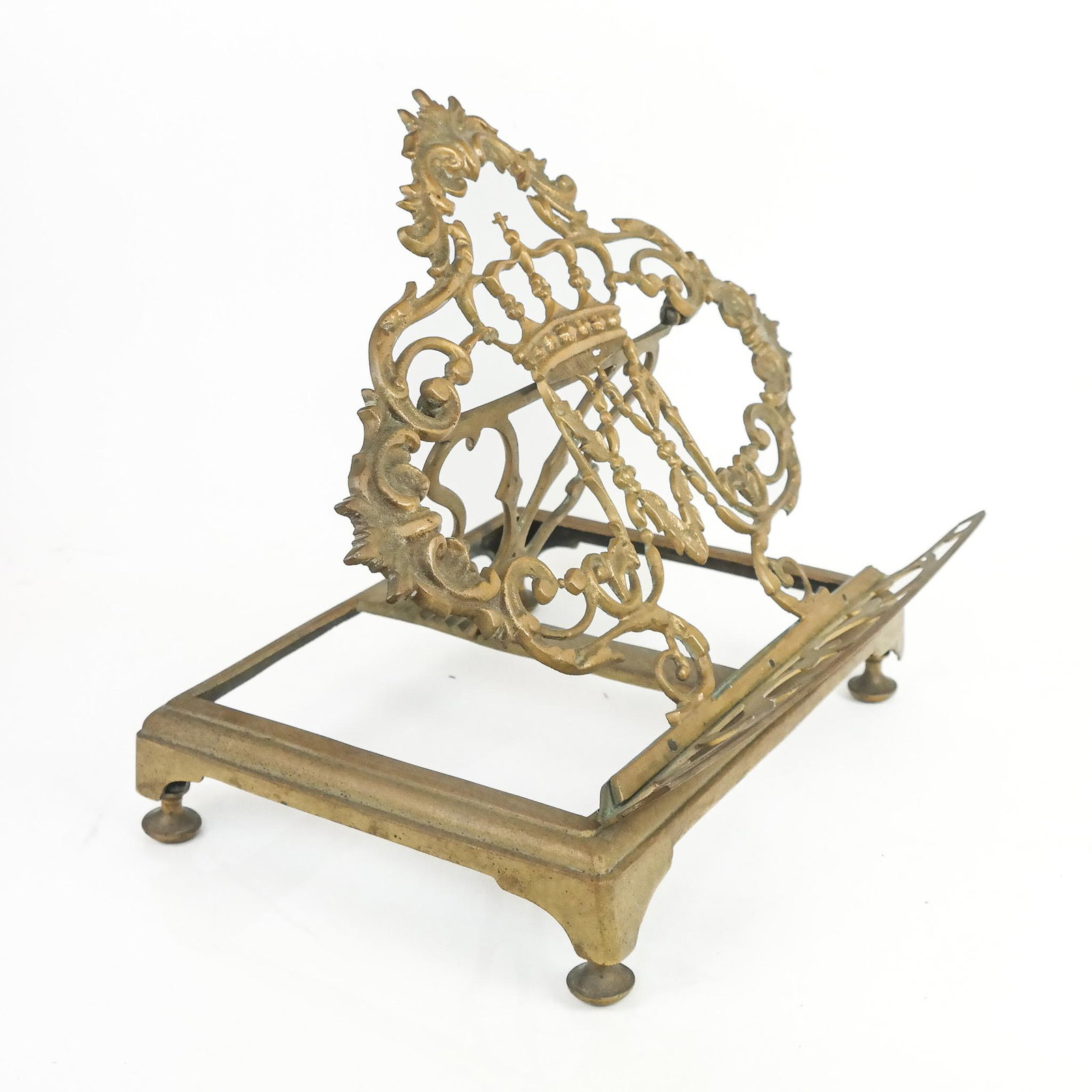 Rococo-Style Gilt Metal Book Easel Stand: Rococo-style gilt metal book easel stand, 20th century, centered with a crown and royal "Ma" cipher inspired by Queen Marie Antoinette of France. [5" H x 11 3/4" W x 9 1/4" D]. Light residue and oxida