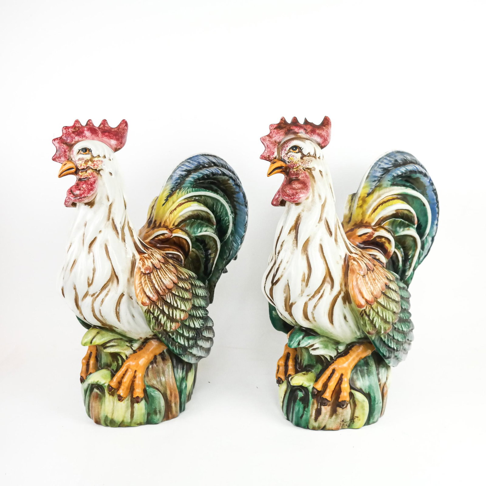Pair of Italian Polychrome Porcelain Clocks: Pair of Italian polychrome porcelain clocks, 20th century, marked inside bases. [16 3/4" H x 15" W x 9" D]. Losses to plume; residue and light wear.
